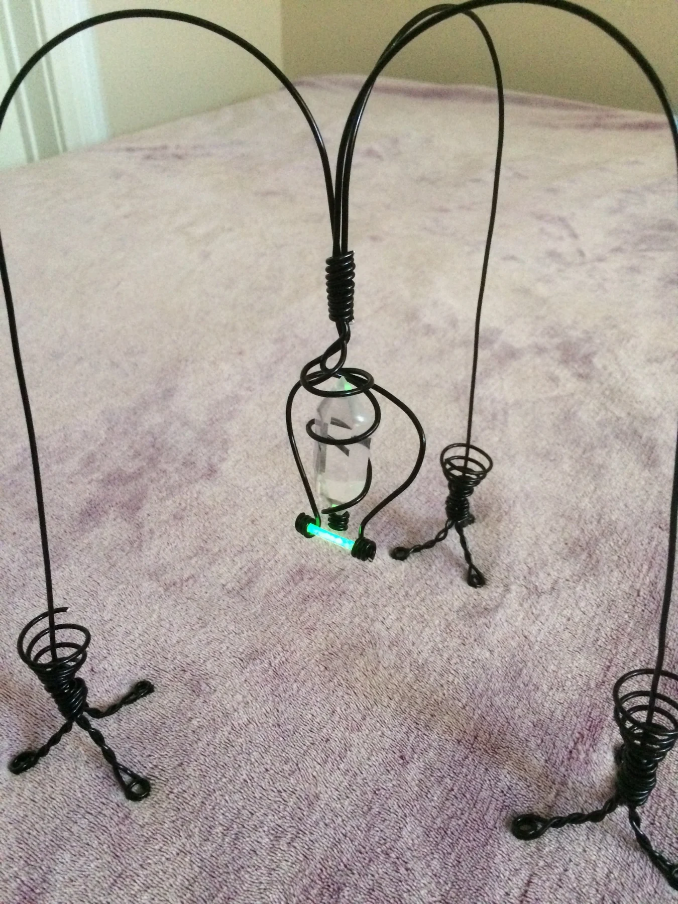 Suspended wire sculpture with small figures