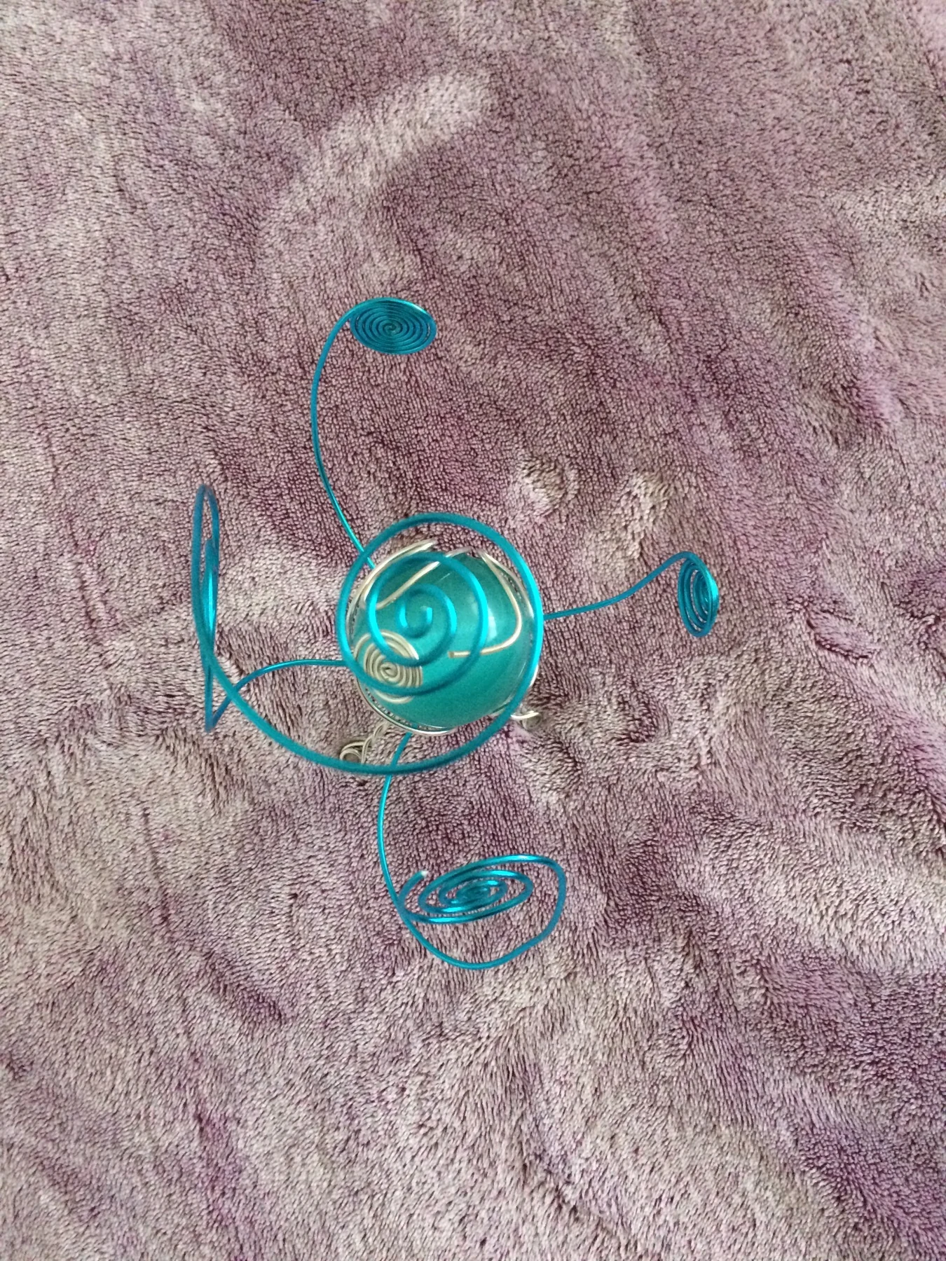Small turquoise spiral wire sculpture