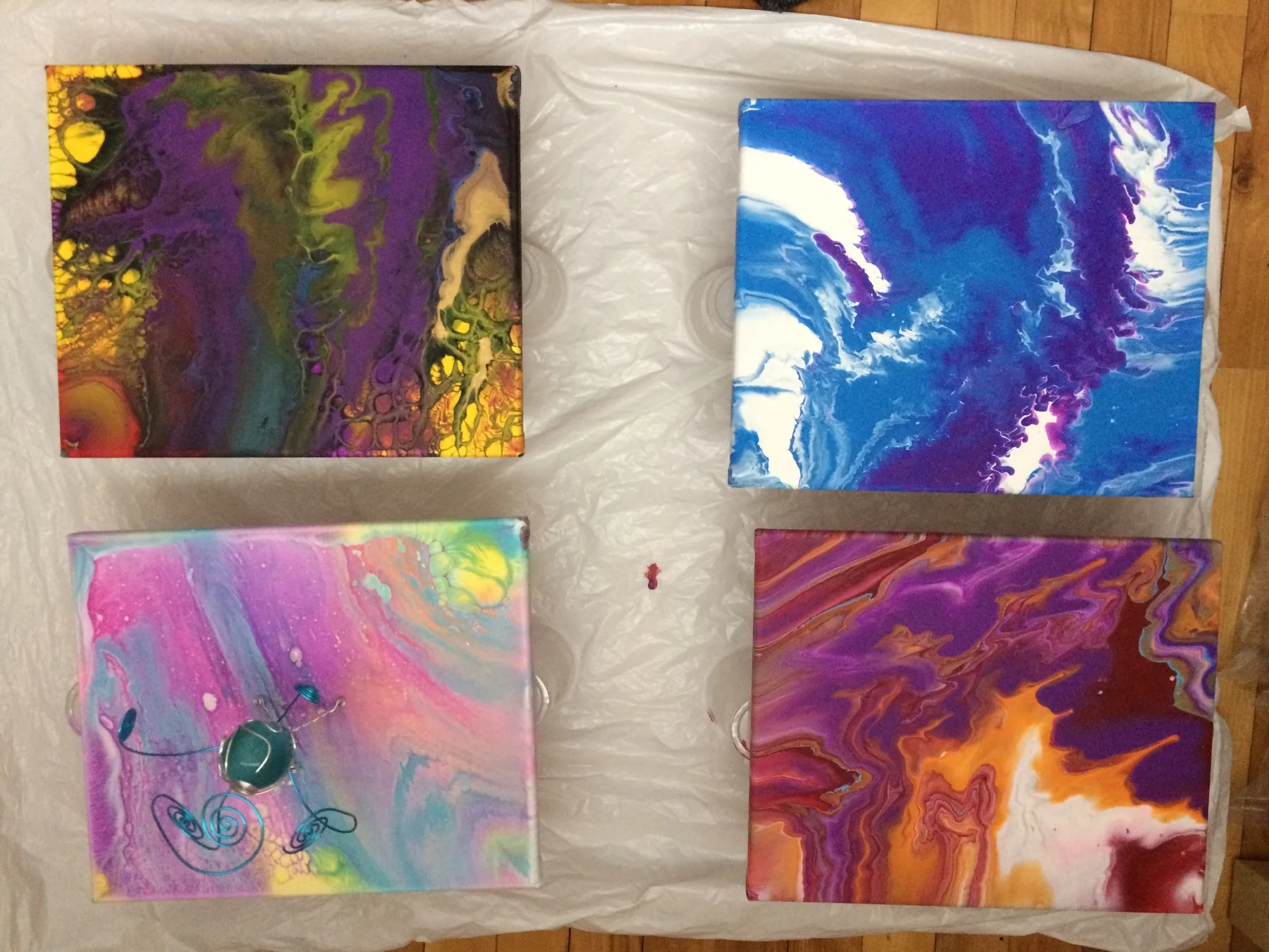 Four small colorful abstract paintings