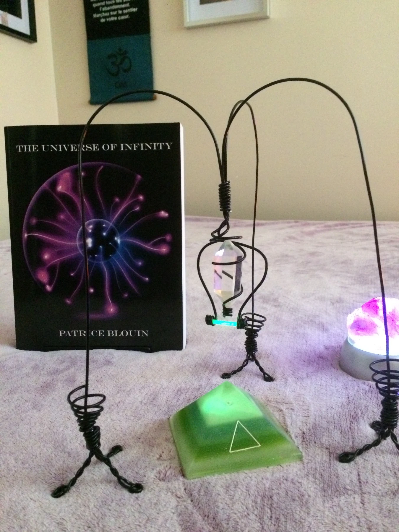 Resin pyramid displayed with wire forms and The Universe of Infinity