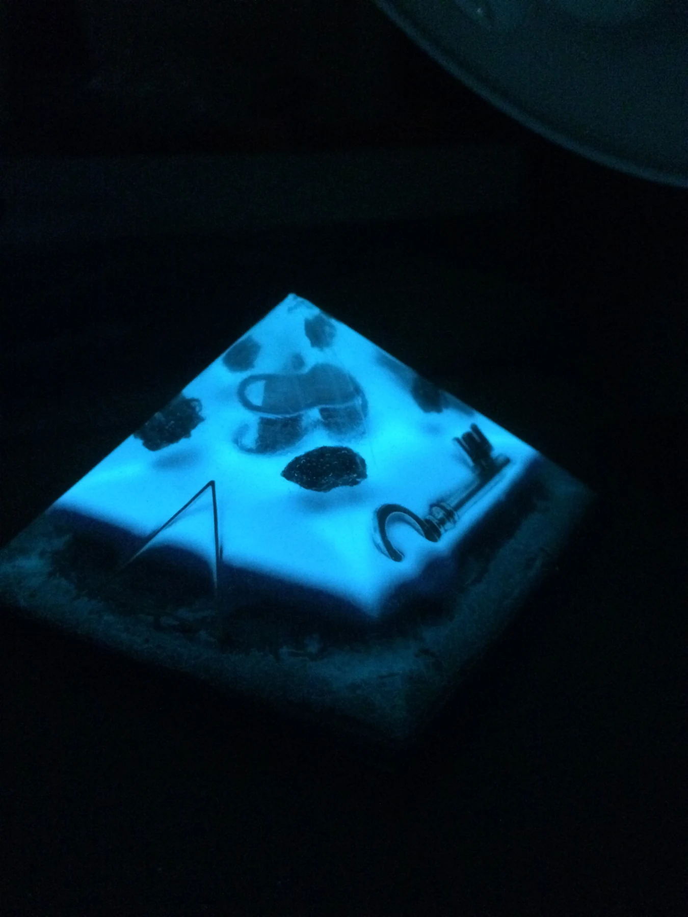 Blue illuminated resin pyramid with embedded key and stones