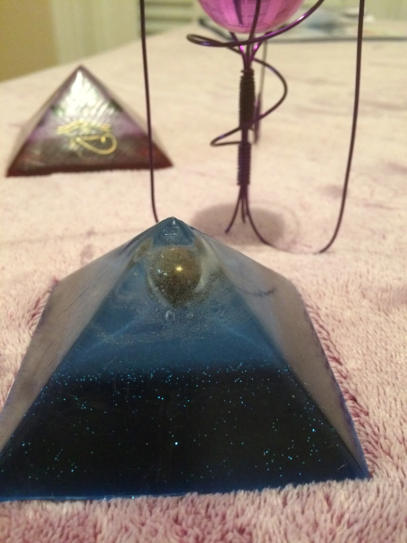 Blue resin pyramid with metallic sphere
