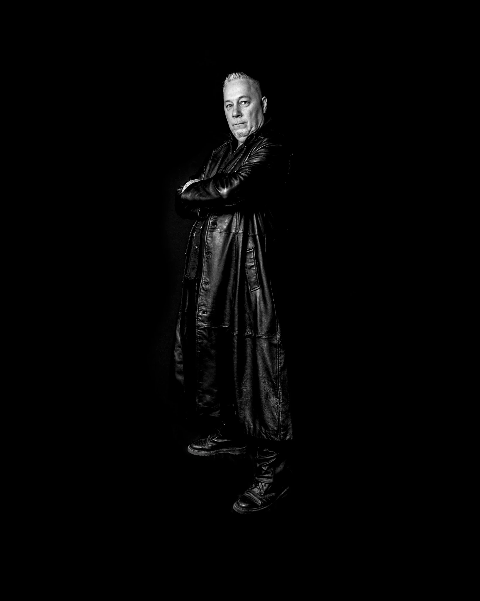 Patrice Blouin in a long black leather coat